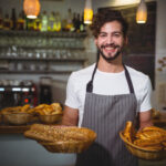 portrait-waiter-holding-basket-bread